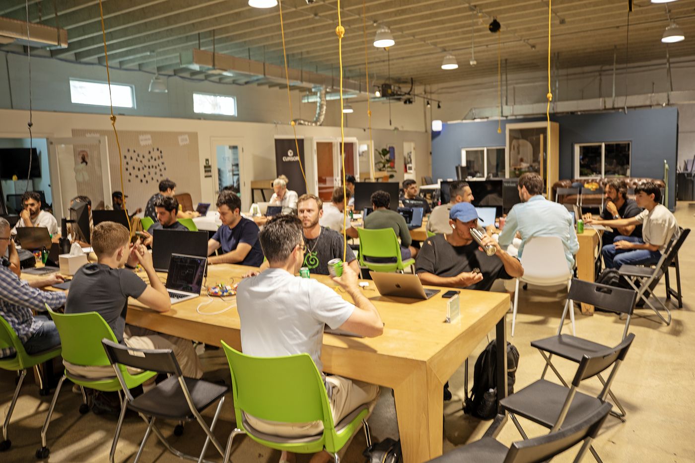 Builders heads-down at tables during the hackathon